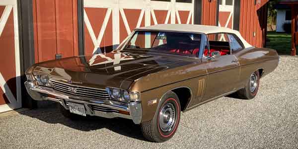 1968 Impala SS 427 on a sunny day in front of a barn.