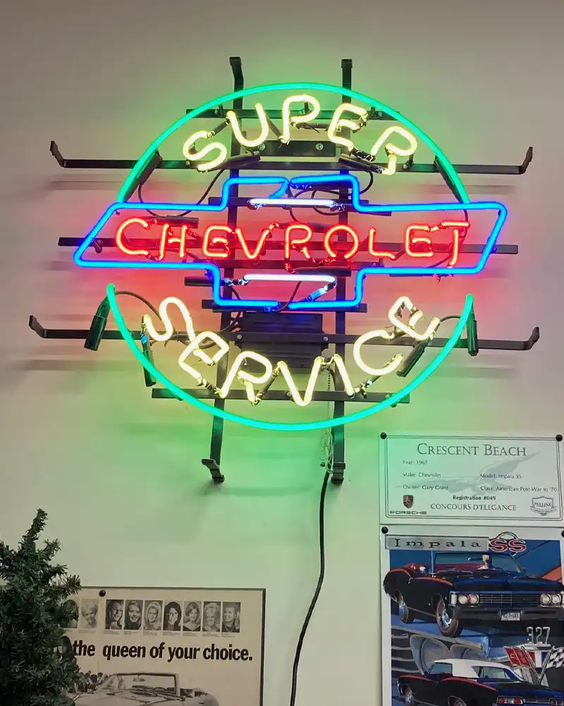 Chevy Muscle Cars Chevrolet Super Service neon sign mounted on wall in a office
